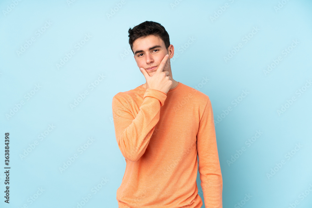 Teenager caucasian handsome man isolated on purple background thinking an idea Teenager caucasian handsome man isolated on purple background thinking an idea
