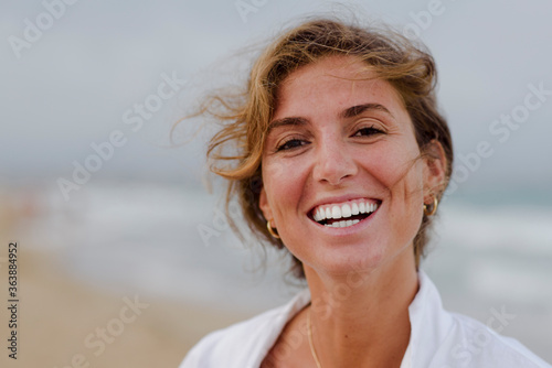 young girl smiling with white teeth outdoors, lifestyle concept