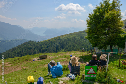 People eating on a restaurant on Capriasca valley over Lugano on Switzerland photo