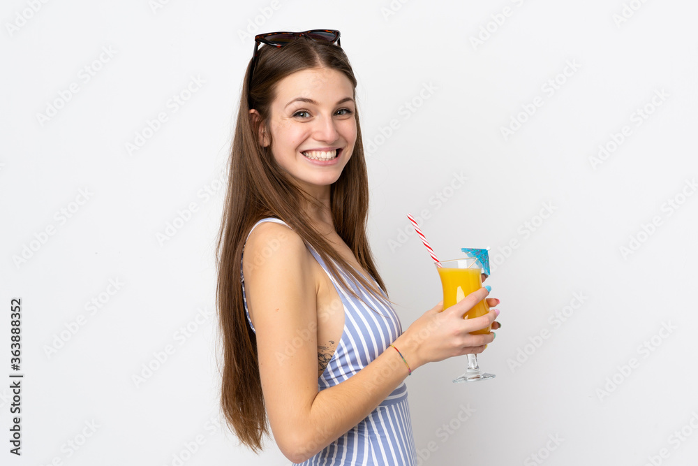 Young caucasian woman isolated on white background in swimsuit and holding a cocktail