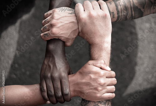 Fototapete Multiethnic  people with black, latin, caucasian and asian hands holding each other wrist