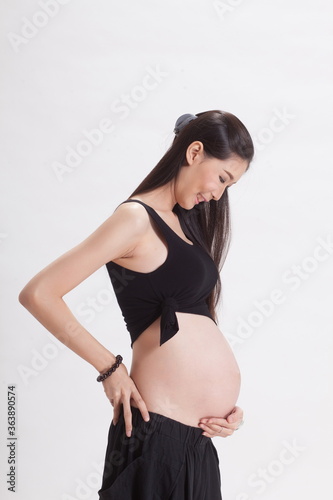 seven months pregnant on white background.