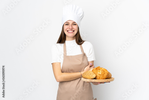 Young woman in chef uniform isolated on white background laughing