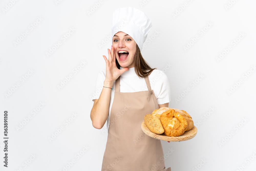 Young woman in chef uniform isolated on white background shouting with mouth wide open Young woman in chef uniform isolated on white background shouting with mouth wide open