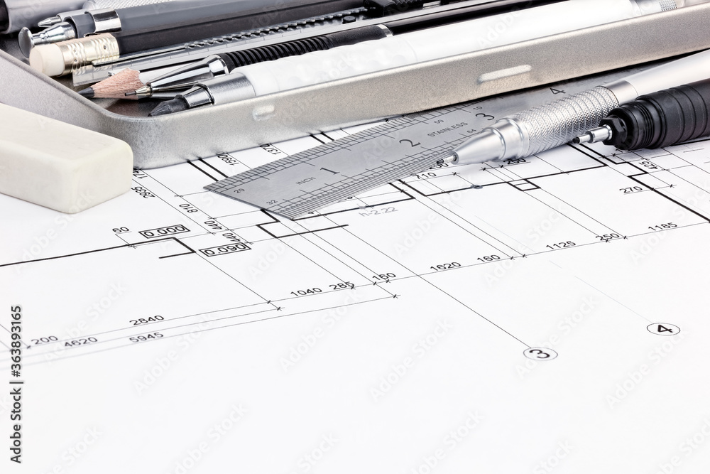 ruler, eraser and pens on graphical blueprints of house interior macro view ruler, eraser and pens on graphical blueprints of house interior macro view