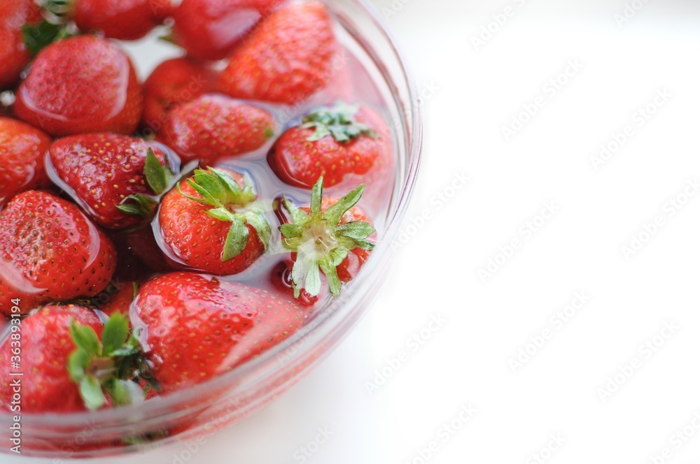 Summer fruits. Home strawberry in bowl with water with copy space Summer fruits. Home strawberry in bowl with water with copy space