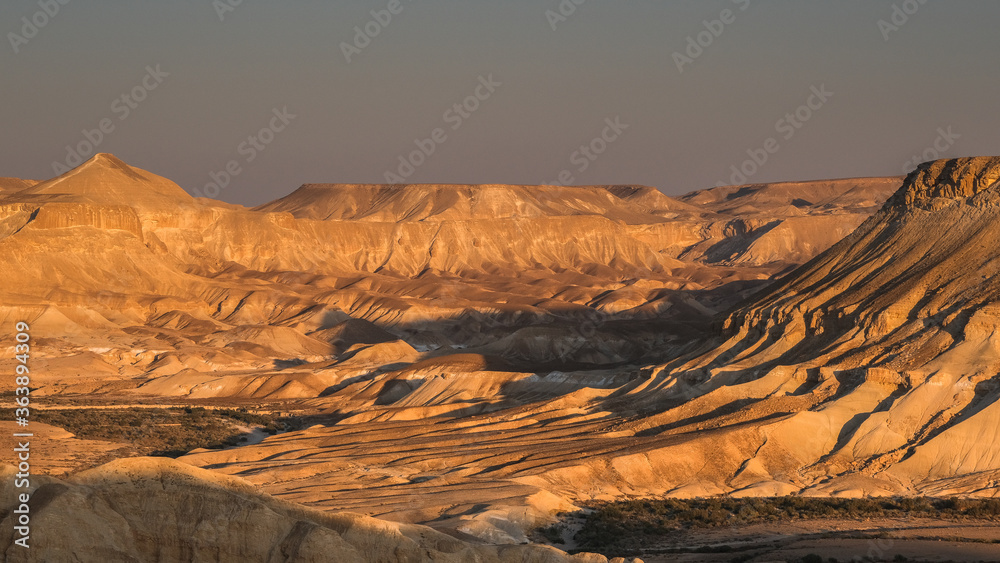 Fototapeta premium View of Nahal Zin, a 120 km long intermittent stream, the largest canyon in country, as seen at sunset from Sde Boker field school, Negev desert, Israel.