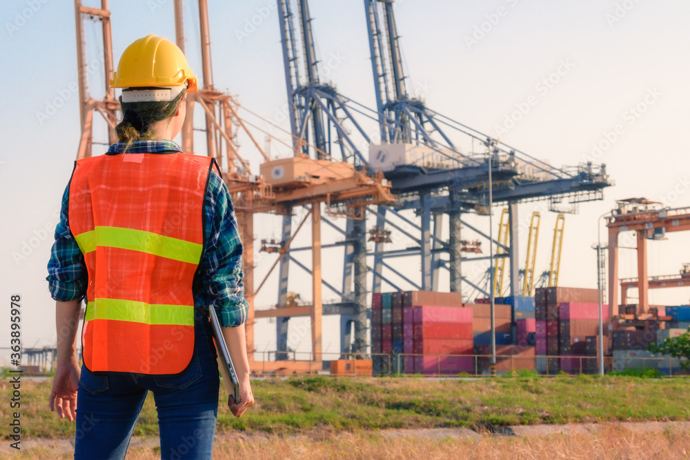 Young Caucasian man and woman worker Check and control loading freight Containers by use radio communication at commercial shipping dock felling happy. Young Caucasian man and woman worker Check and control loading freight Containers by use radio communication at commercial shipping dock felling happy.