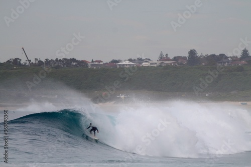 Canvas Print Person surfing in the sea at daytime