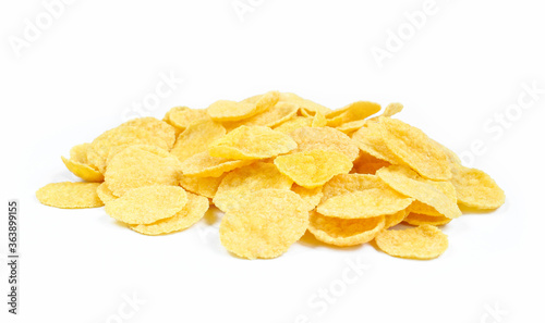 Pile of yellow cornflakes isolated on white background. Delicious dry cereals