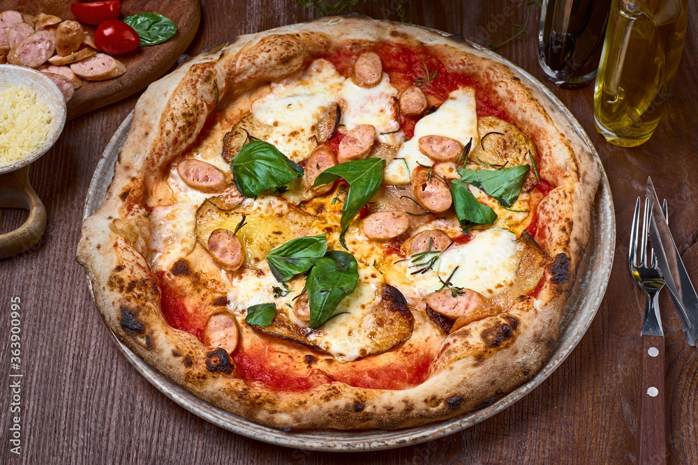 Pizza with topping pork sausage, Italian sausage, pepperoni, ham, bacon, mozzarella cheese on dark a wooden table. Healthy food Pizza with topping pork sausage, Italian sausage, pepperoni, ham, bacon, mozzarella cheese on dark a wooden table. Healthy food