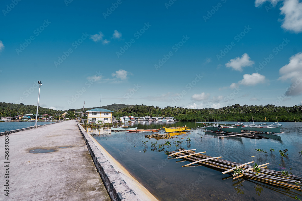 Landscape with pier and fishing boats. Siargao, Philippines.