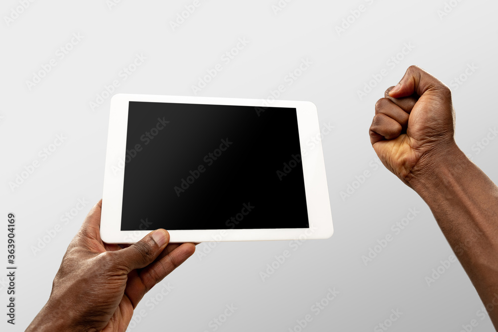 Cheering, excited. Close up male hands holding smartphone with blank screen during online watching of popular sport matches, championships. Copyspace for ad. Devices, gadgets, technologies concept. Cheering, excited. Close up male hands holding smartphone with blank screen during online watching of popular sport matches, championships. Copyspace for ad. Devices, gadgets, technologies concept.