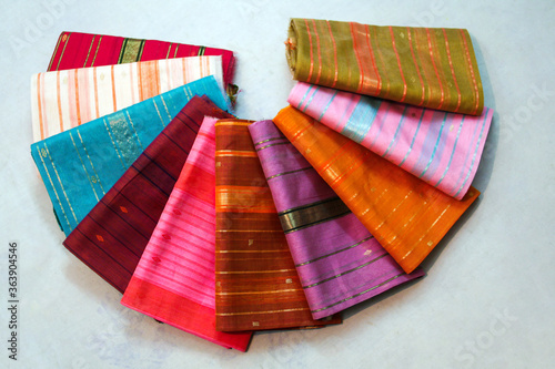 Photos Maheshwari saris in a textile shop, displayed in front of customers