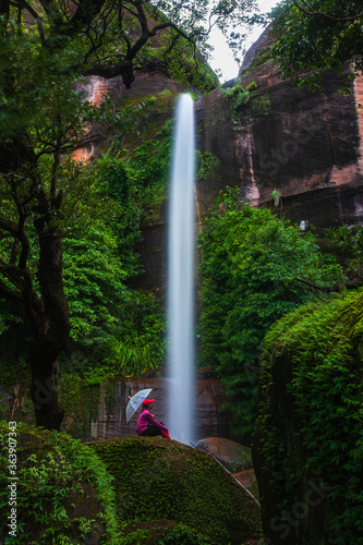 Young girl hiking in Tad-Wiman-Thip waterfall, Beautiful waterwall in Bung-Kan province, ThaiLand.