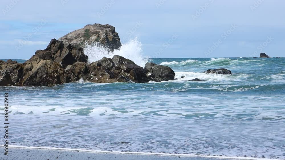 Surf splashing wildly over the rocks tide coming in slow motion Surf splashing wildly over the rocks tide coming in slow motion