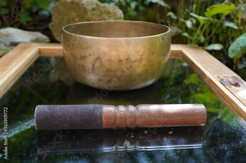Bronze Tibetan singing bowl with wooden stick.