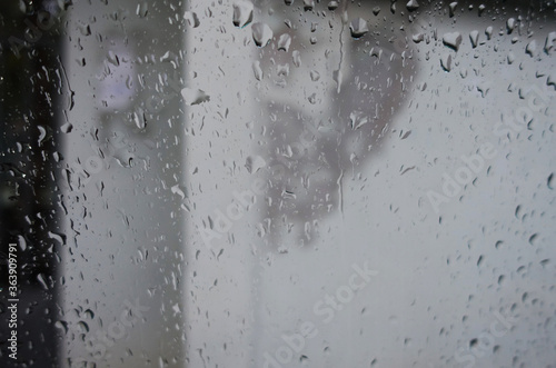 Many rain drops on window, abstract black and white background