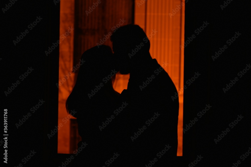 silhouette of a couple kissing