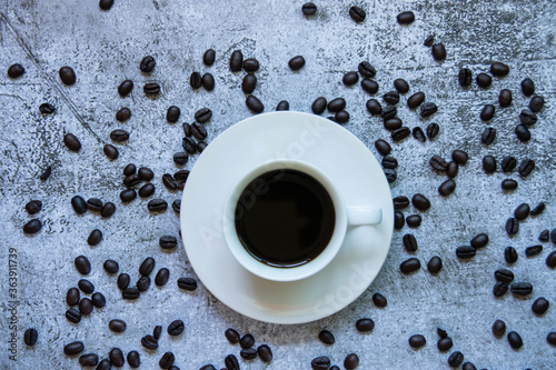  Coffee cups and roasted coffee beans On the cement background © Poohbest