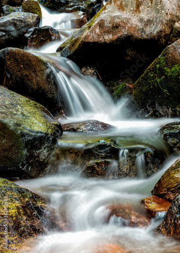 Fototapeta Naklejka Na Ścianę i Meble -  calm mountain stream rapids over colrful rocks and stones
