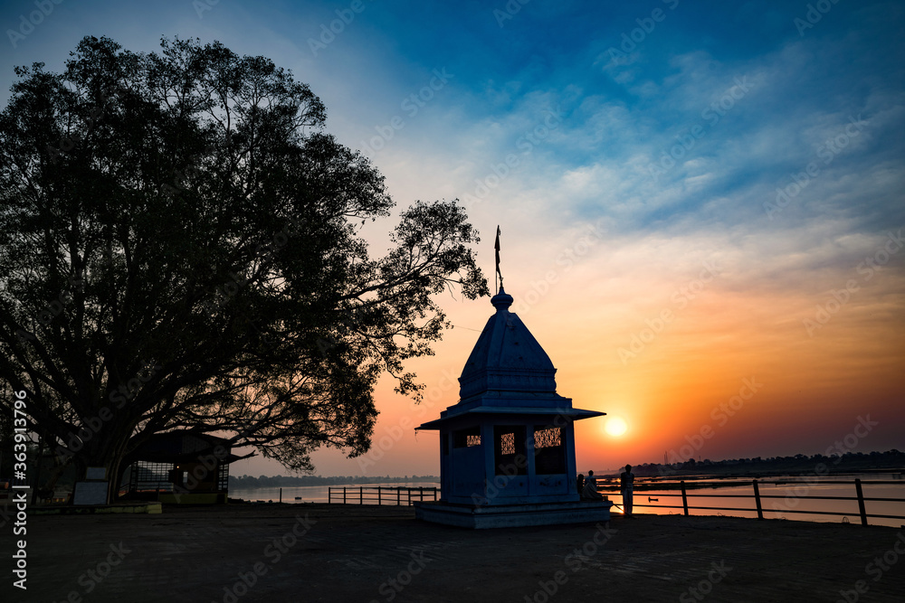 Dusk time at Cheepaner Ghat with holy Narmada river and temple, Madhya Pradesh, India. Dusk time at Cheepaner Ghat with holy Narmada river and temple, Madhya Pradesh, India.