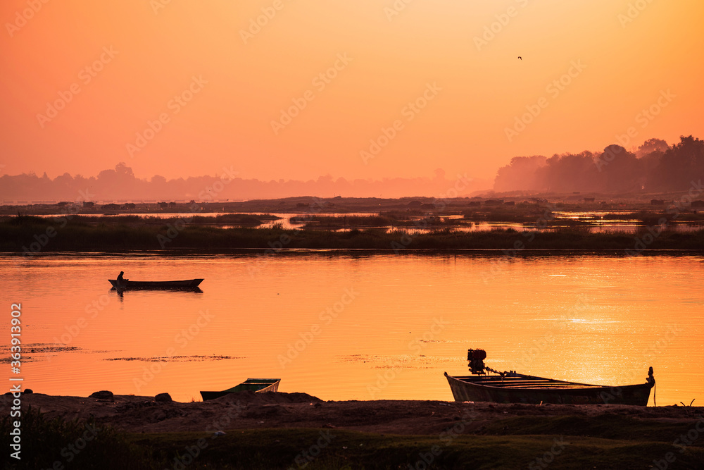 A colorful dawn over the river Narmada with sunrise at Cheepaner Ghat, Madhya Pradesh, India. A colorful dawn over the river Narmada with sunrise at Cheepaner Ghat, Madhya Pradesh, India.