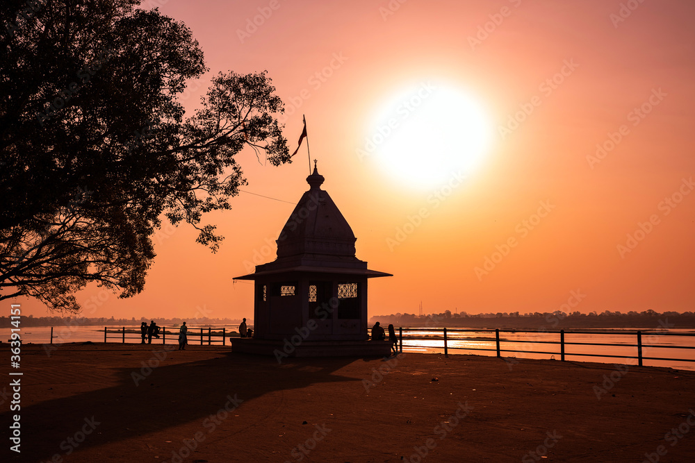 Dusk time at Cheepaner Ghat with holy Narmada river and temple, Madhya Pradesh, India. Dusk time at Cheepaner Ghat with holy Narmada river and temple, Madhya Pradesh, India.