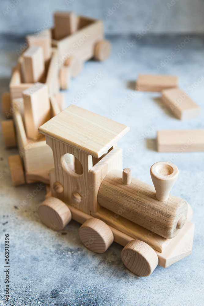 Children's wooden toys. Children wooden train with wagons. Natural wood construction set. Educational equipment. Children's wooden locomotive with various cargo
