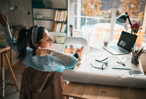 a young woman spends time preparing her architectural work at home