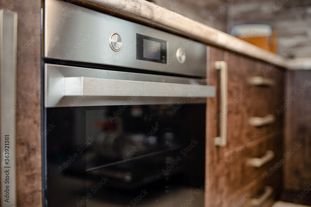 Fototapeta premium Modern kitchen interior in wenge colors with built-in appliances