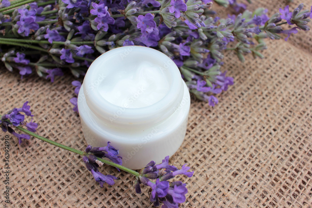 DIY face or eye cream with fresh lavender flowers on burlap fabric texture. Organic herbal cosmetic concept. Selective focus
DIY face or eye cream with fresh lavender flowers on burlap fabric texture. Organic herbal cosmetic concept. Selective focus