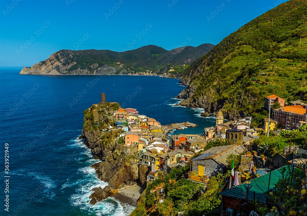 A view along the Cinque Terre coast towards the colourful village of Vernazza, in the summertime