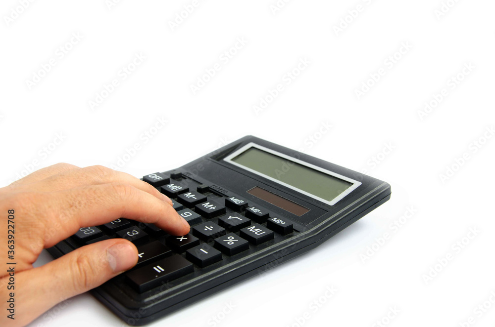 hand presses a button on a large calculator white background
hand presses a button on a large calculator white background
