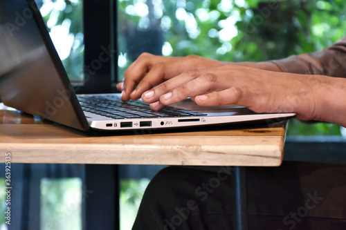 Closeup image hands of business people are working and typing on laptop keyboard between online communicate with customer. Business and Technology concept.