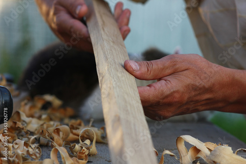 carpenter's hands at work on wood processing