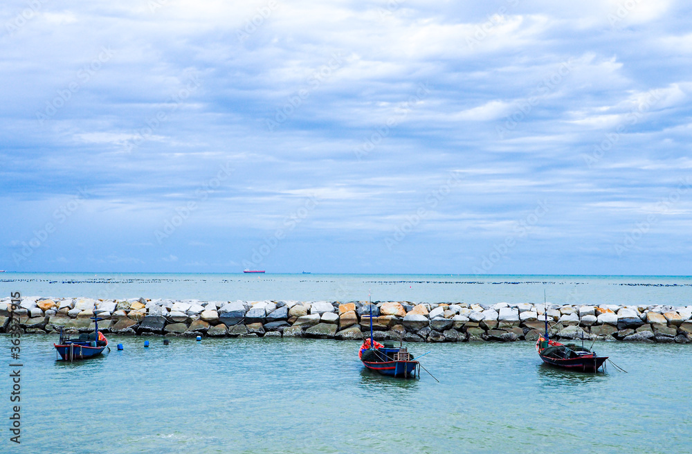 A fishing boat floating on the sea, complete with fishing equipment