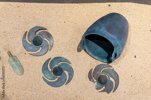 Pinwheel-shaped shield ornament, spear tip and Pot made of bronze found at Daeseong-dong Tumuli or tombs of Gaya kingdom in Gimehae, South Gyeongsang province, South Korea. photo