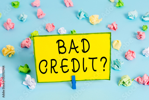 Word writing text Bad Credit Question. Business photo showcasing a bad credit score due to nonpayment of loans Colored crumpled papers empty reminder blue floor background clothespin