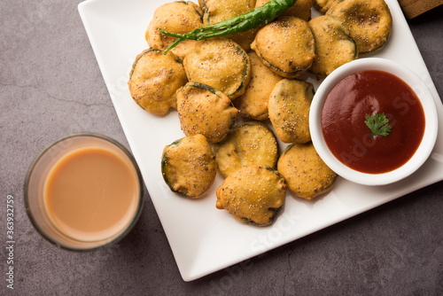 Sponge gourd fritters or gilki bhaji or bajji or pakora is an Indian snack item, served with tomato ketchup, selective focus photo