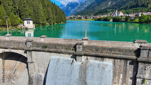 Fototapeta Naklejka Na Ścianę i Meble -  Alpin lake and dam in summertime, view from drone, Auronzo, italian dolomites
