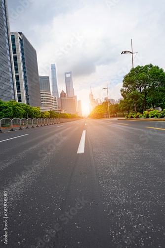 Highways and tall buildings stretch under the blue sky at dusk.