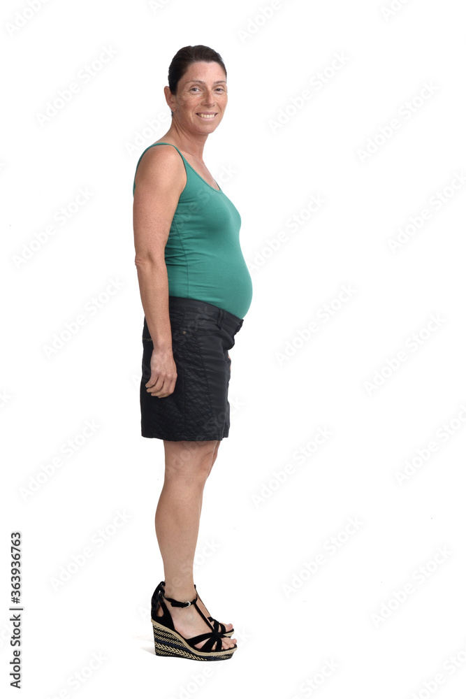 side view of a pregnant woman looking at camera on white background side view of a pregnant woman looking at camera on white background