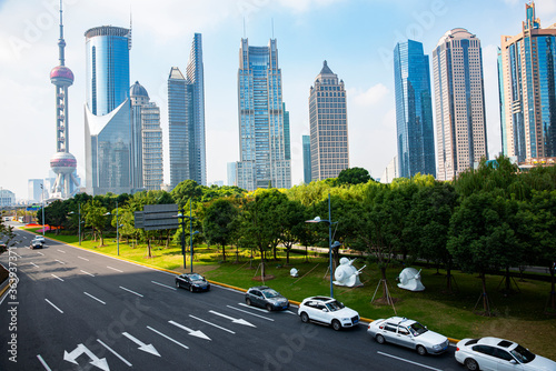 A cluster of tall buildings and cars on the highway in Shanghai