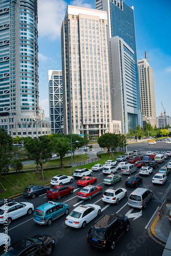 A cluster of tall buildings and cars on the highway in Shanghai