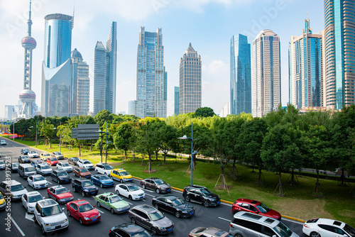 A cluster of tall buildings and cars on the highway in Shanghai