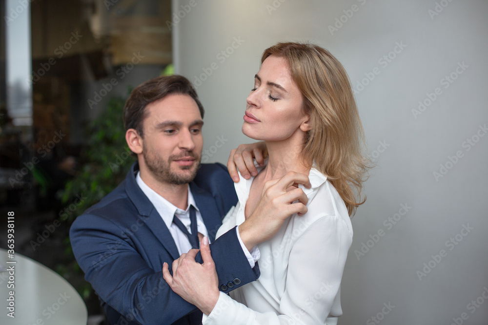 Workplace romance. Two business people passion flirting at job. Erotic couple sitting together at office desk. Sexual enjoyment concept. Workplace romance. Two business people passion flirting at job. Erotic couple sitting together at office desk. Sexual enjoyment concept.