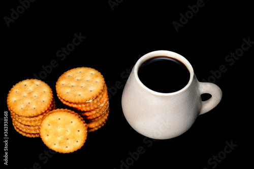 white plate with lemon cookies with cup of coffee seen from above
