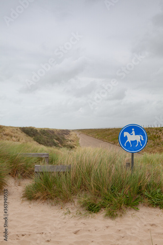 Blue road sign for riders on the beach in De Putten in Netherlands.