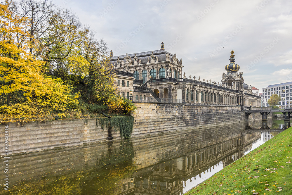 Colorful autumn view of Zwinger from channel. Zwinger Palace was royal palace XVII century in Dresden, Germany. 